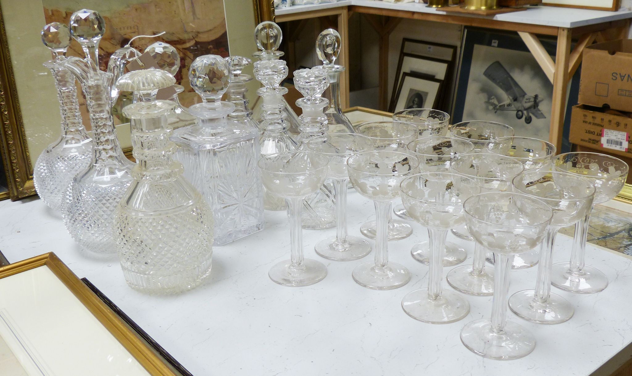 A Victorian diamond cut claret jug and decanter, assorted other decanters and champagne flutes